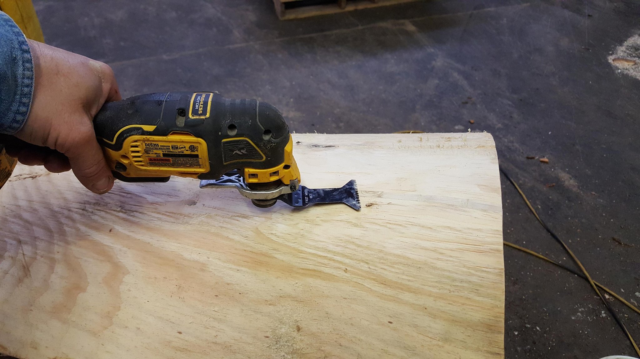 Second pass with the DeWalt oscillating tool — foam trimmed nearly flush, surface clean and smooth, crack fully sealed